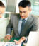 Group of business partners interacting at meeting in office