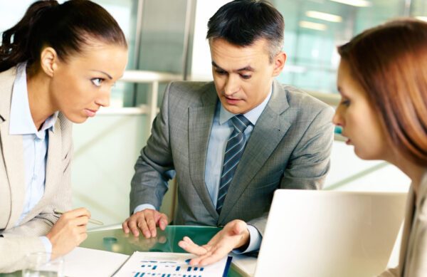 Group of business partners interacting at meeting in office