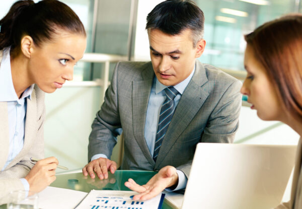 Group of business partners interacting at meeting in office