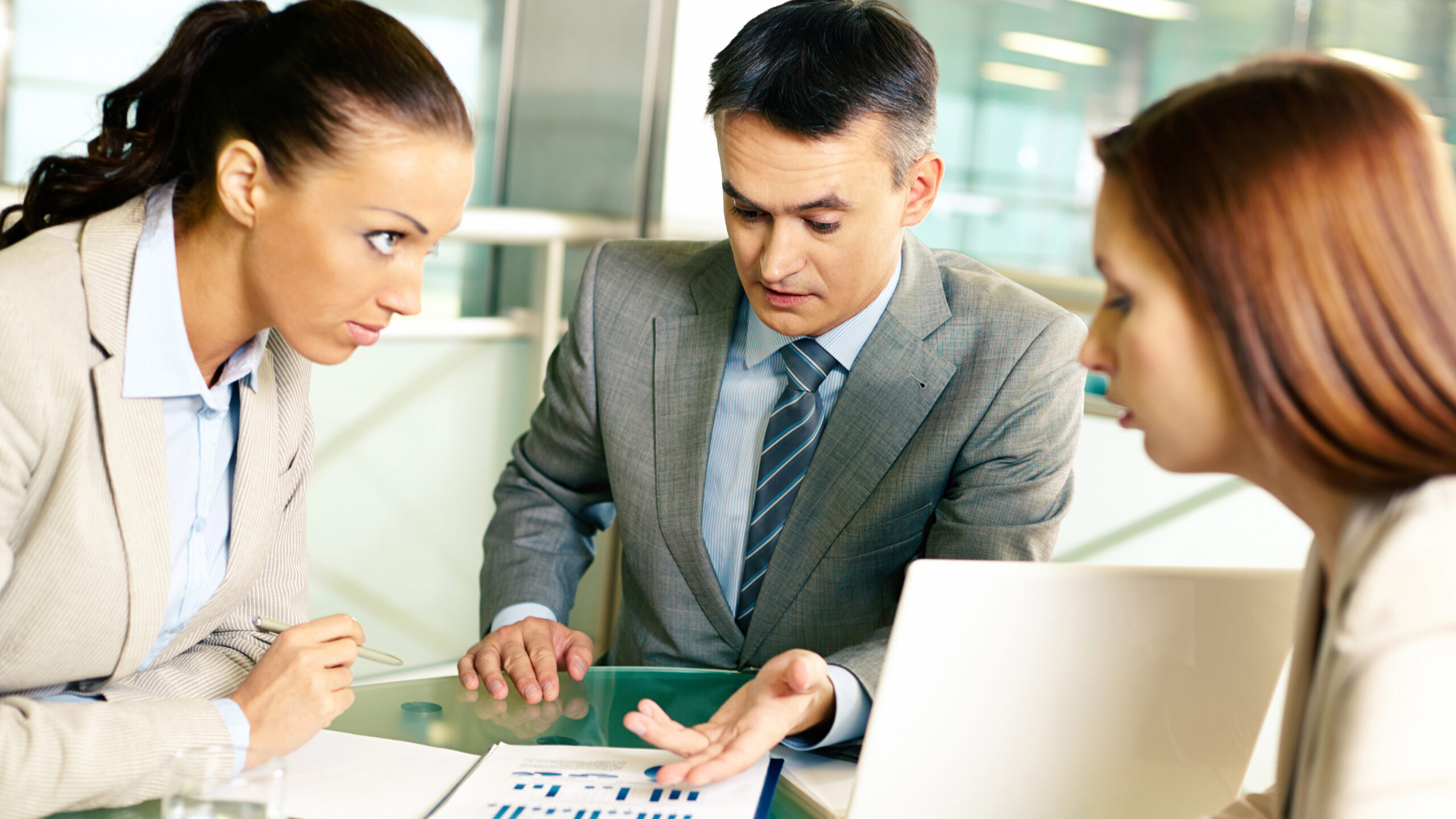 Group of business partners interacting at meeting in office